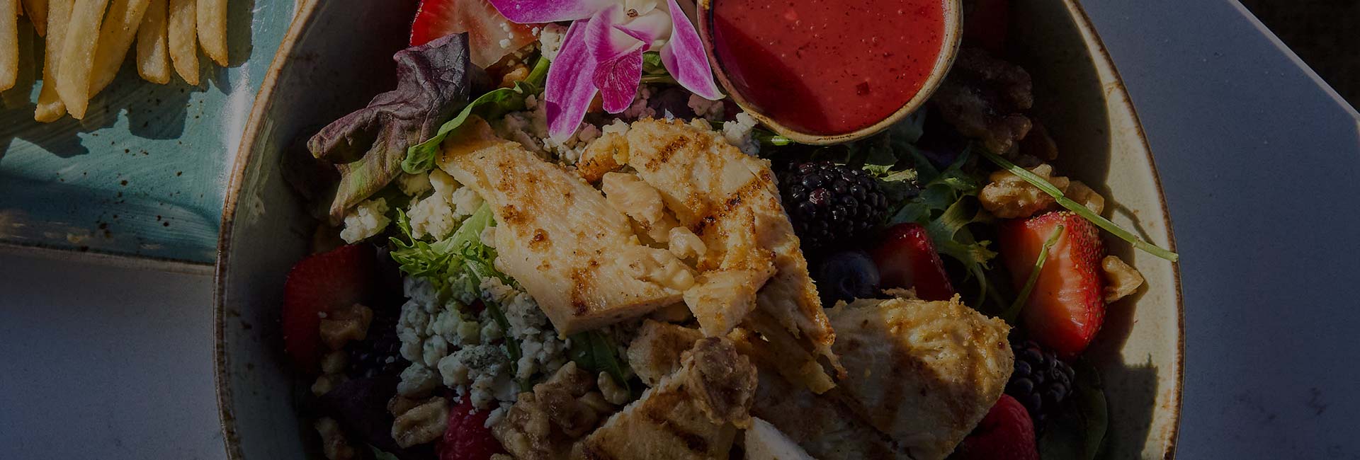 ERA Cafe garden salad topped with grilled chicken breast. ERA Cafe garden salad topped with grilled chicken breast.