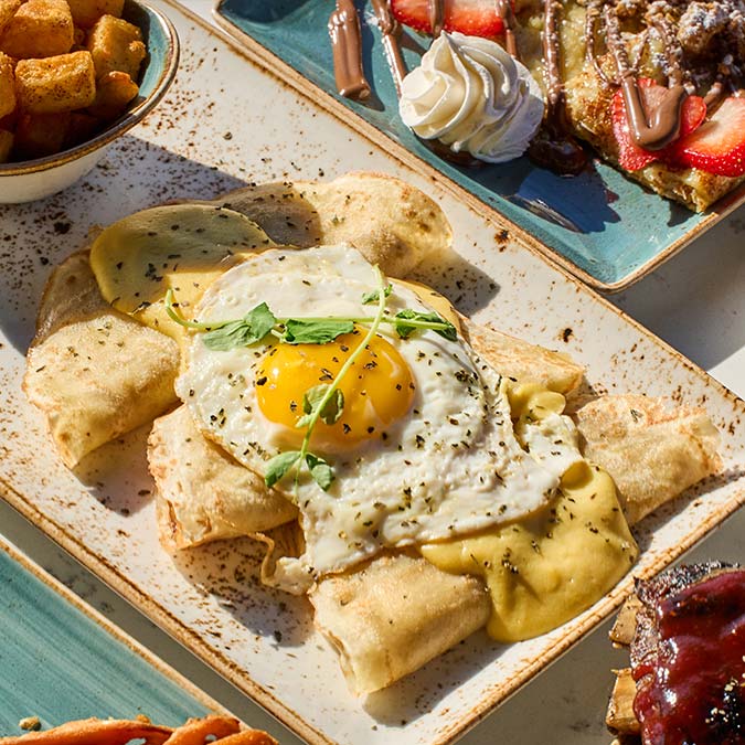 ERA Cafe in Waunakee, WI Crepes with sunny-side-up egg, herbs, tater tots & waffles—best Breakfast Brunch & Lunch in Waunakee.