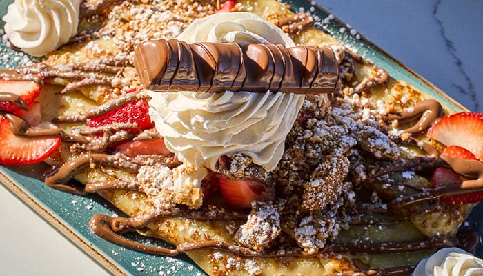 ERA Cafe in Waunakee, WI Crepe topped with whipped cream, strawberries, and chocolate—Best Breakfast in Waunakee Wisconsin.