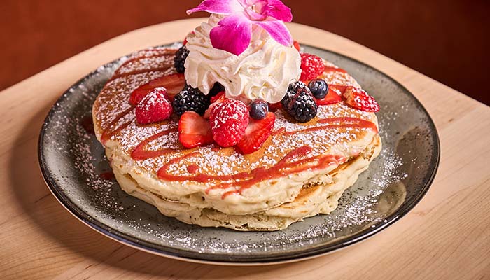 ERA Cafe in Waunakee, WI Stack of pancakes with berries, whipped cream, and powdered sugar—Best Breakfast in Waunakee Wisconsin.