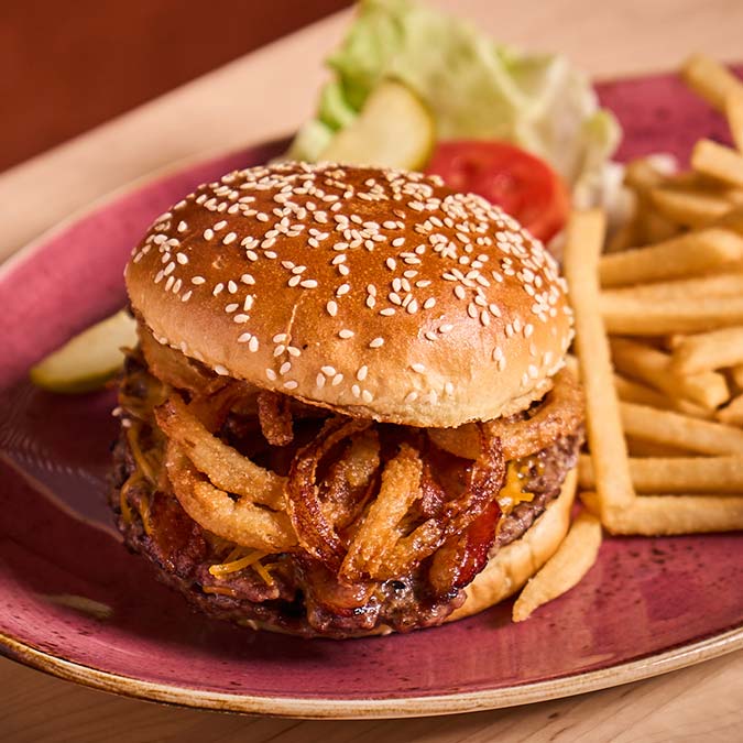 ERA Cafe in Waunakee, WI Cheeseburger with crispy onions, fries, lettuce, and tomato at Breakfast Brunch & Lunch Waunakee.