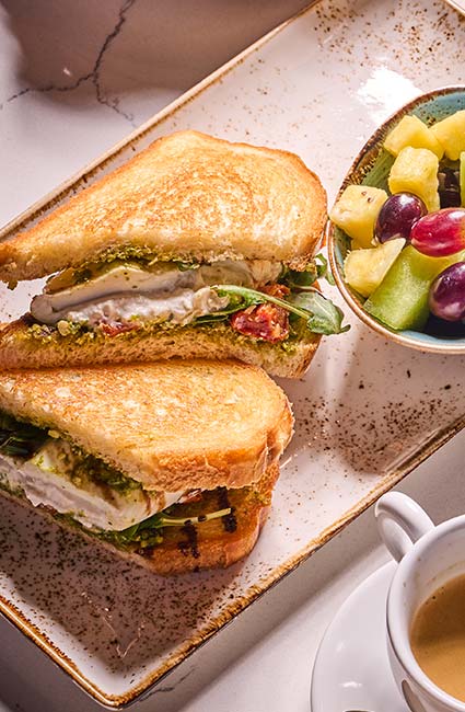 ERA Cafe in Waunakee, WI Grilled sandwich with greens, fruit salad, and coffee—perfect for Breakfast Brunch & Lunch in Waunakee.