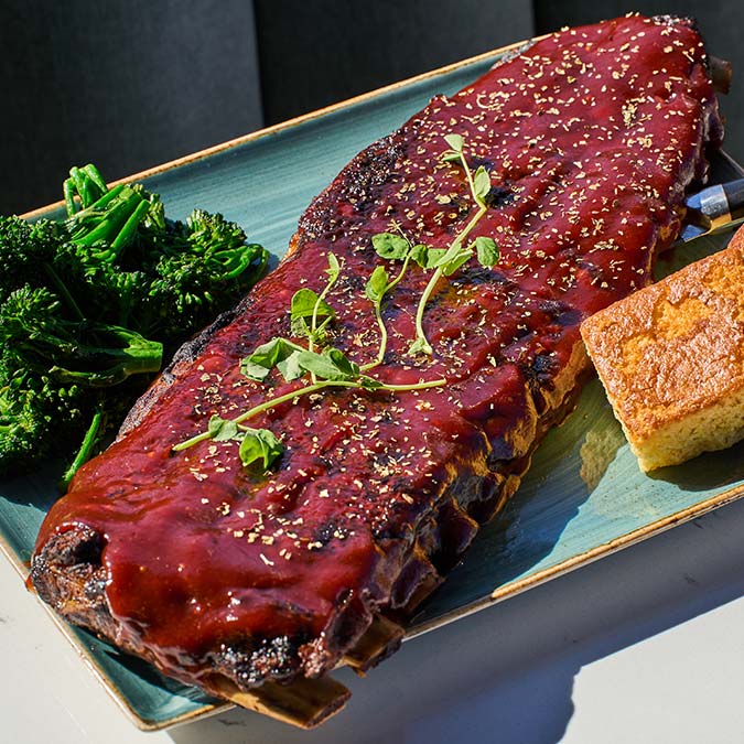 ERA Cafe in Waunakee, WI A plate with glazed ribs, broccolini, and cornbread—Breakfast Brunch & Lunch in Waunakee Wisconsin.