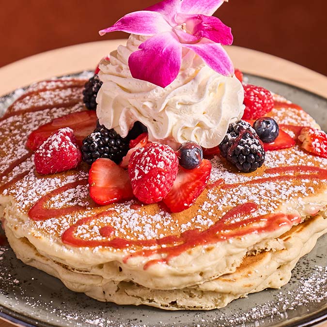ERA Cafe in Waunakee, WI Stack of pancakes topped with berries and cream—perfect for Breakfast Brunch & Lunch in Waunakee.