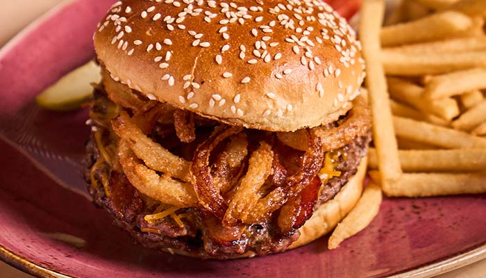ERA Cafe in Waunakee, WI A cheeseburger with crispy onion rings and fries—perfect for lunch in Wausau, Wisconsin.