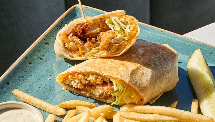 ERA Cafe in Waunakee, WI Halved wrap with chicken, lettuce, fries, and pickle—perfect for lunch in Wausau Wisconsin.